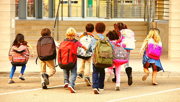 Children running towards school